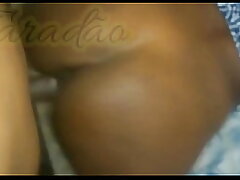 In the dark-hued girl's slit and backside