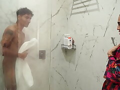 Big-assed stepmom ends up fucking her skinny stepson after spying on him in the shower