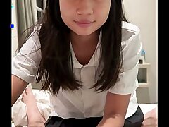 An 18-year-old Asian girl in a school uniform gets fucked by a big white cock