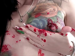 Tattooed babe Marie Bossette covers herself in sizzling wax