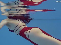 Petite Russian Marfa swims naked in the pool