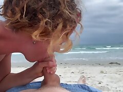 Deep blowjob on the beach, lady in swimsuit fellating cock, jizz mouth outdoors