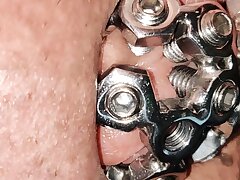 close up of the set screw in my chastity cell
