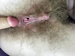 Unshaved gal fucks her wet big love button cooter with fuck stick in close up